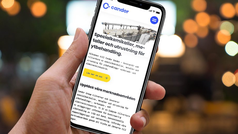 Person håller i en iPhone X och är inne på Candor Swedens hemsida